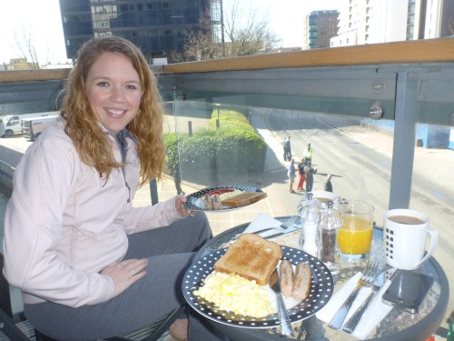 Eating breakfast while we watch other people run.  At Mile 17.