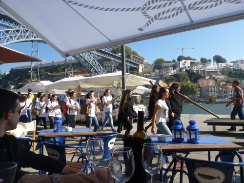 Students in robes walking by the river